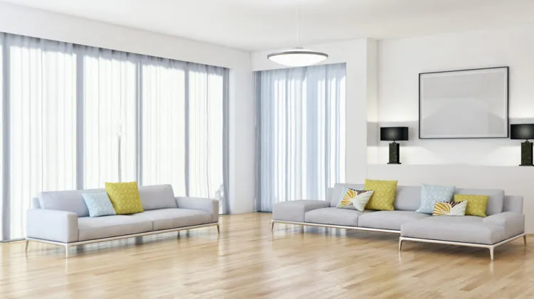 a living room with white furniture