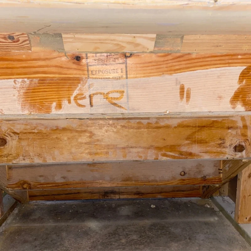 white powder on wood under stairs